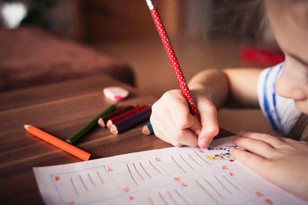 Child writing on a desk