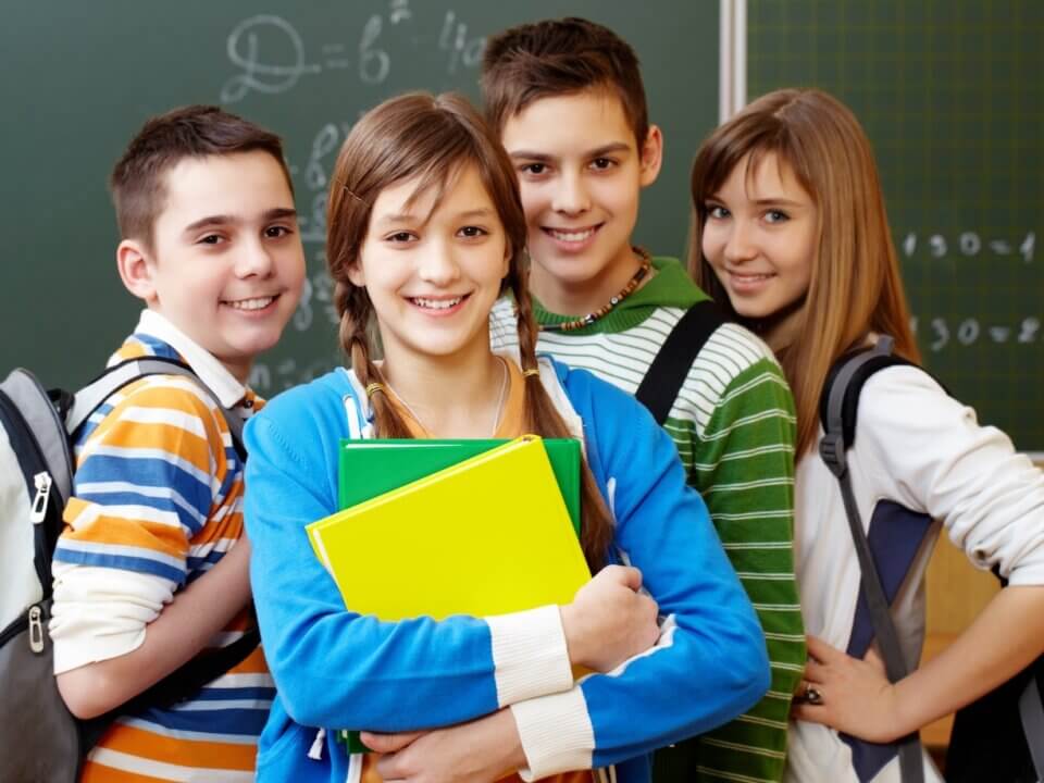 smiling students with backpacks
